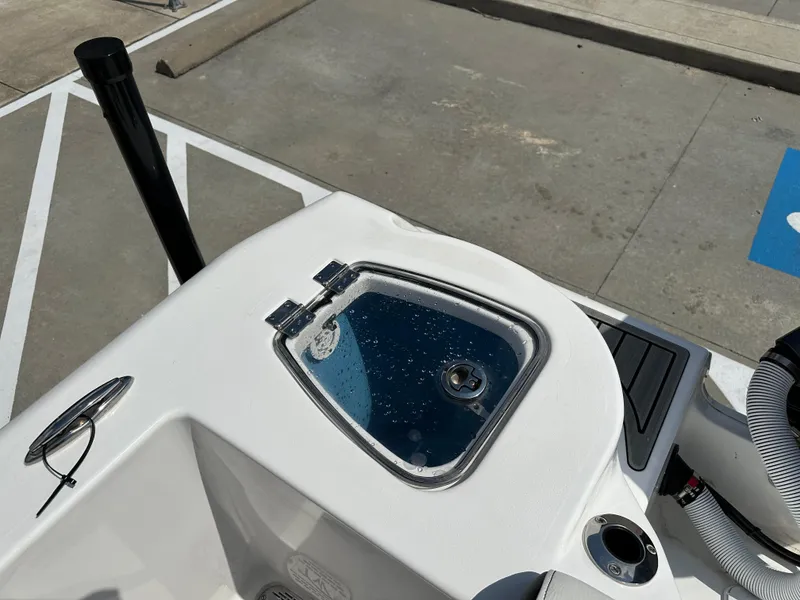 Slide: The Image of Tidewater 210CC 2025 boat detail with open hatch and visible hardware. - 18