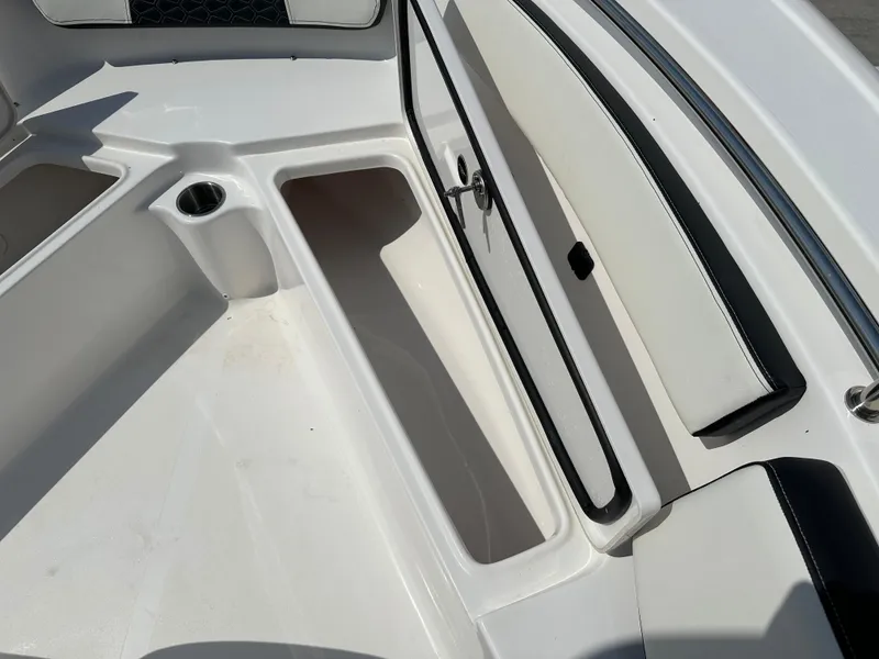 Slide: The Image of Interior view of 2025 Tidewater 210CC boat, featuring seating and storage compartments. - 26