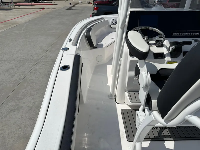 Slide: The Image of 2025 Tidewater 210CC boat interior with steering console and seating. - 33