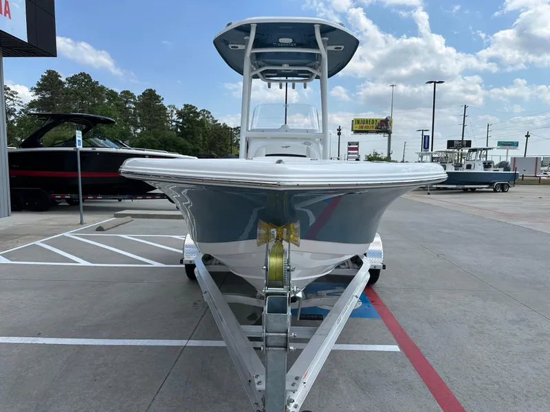 Slide: The Image of 2025 Tidewater 210CC boat on trailer in parking lot, under a partly cloudy sky. - 5