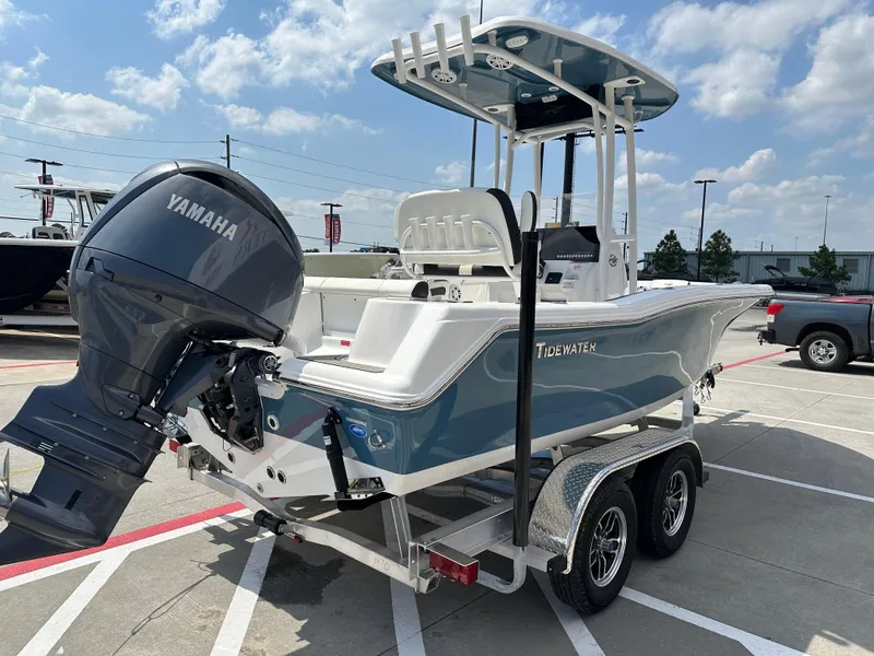 Slide: The Image of 2025 Tidewater 210CC boat on trailer with Yamaha outboard motor, parked outdoors. - 8
