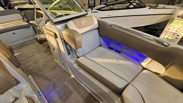 Slide: The Image of 2020 Crownline E 215 XS boat interior with luxurious seating and ambient lighting. - 21