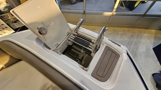 Slide: The Image of 2020 Crownline E 215 XS boat with open storage compartment and ladder. - 23