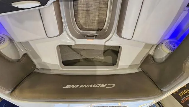 Slide: The Image of 2020 Crownline E 215 XS boat interior with seating and storage compartments. - 25