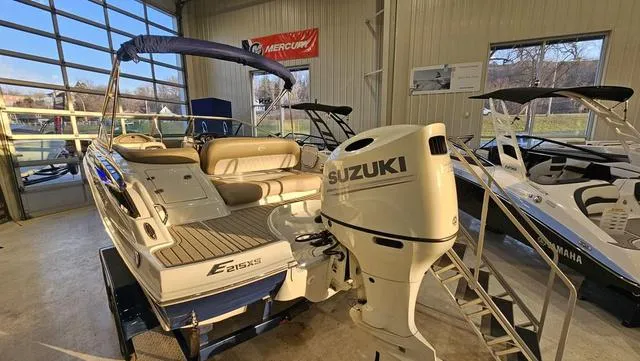Slide: The Image of 2020 Crownline E 215 XS boat with Suzuki outboard motor in showroom. - 5