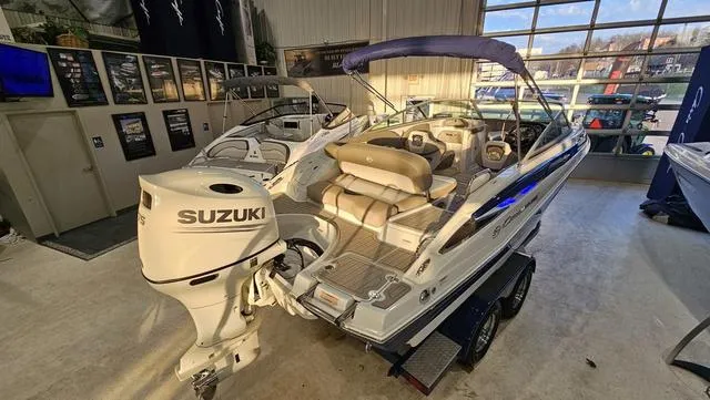 Slide: The Image of 2020 Crownline E 215 XS boat with Suzuki outboard motor in showroom. - 6