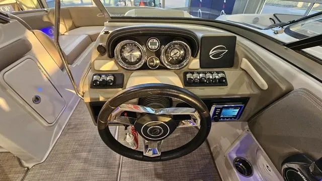 Slide: The Image of 2020 Crownline E 215 XS boat dashboard with steering wheel and control panel. - 17