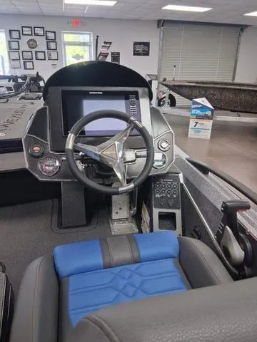 Slide: The Image of 2025 Vexus VX S20 boat cockpit with modern steering and control panel. - 11
