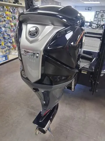 Slide: The Image of 2025 Vexus VX S20 outboard motor displayed in a showroom setting. - 14