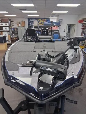 Slide: The Image of 2025 Vexus VX S20 boat in showroom, featuring advanced fishing equipment and spacious deck. - 3