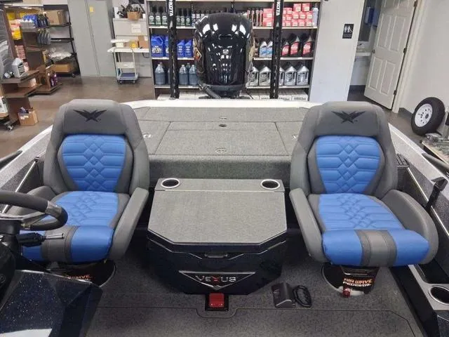 Slide: The Image of 2025 Vexus VX S20 boat interior with blue and gray seating, cup holders, and storage compartments. - 8