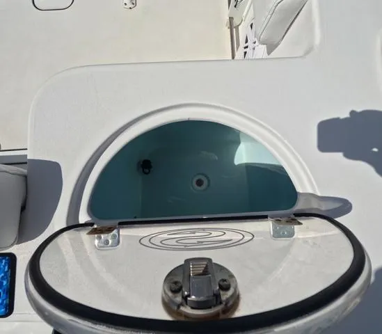 Slide: The Image of 2021 Sportsman Open 232 boat livewell with open lid, showcasing interior. - 10