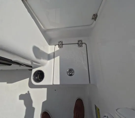 Slide: The Image of 2021 Sportsman Open 232 boat interior, featuring storage compartment and cup holder. - 12