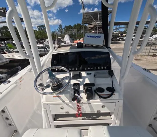 Slide: The Image of 2021 Sportsman Open 232 boat dashboard with Lowrance system, steering wheel, and controls. - 17