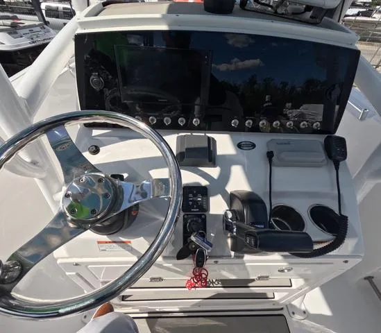 Slide: The Image of 2021 Sportsman Open 232 boat dashboard with steering wheel and control panel. - 18