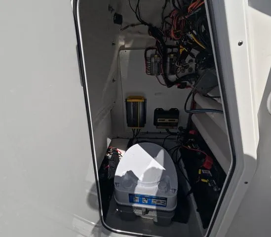 Slide: The Image of 2021 Sportsman Open 232 boat interior wiring and equipment compartment view. - 19