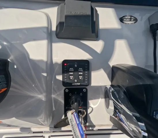 Slide: The Image of Control panel of a 2021 Sportsman Open 232 boat with key ignition and switches. - 20