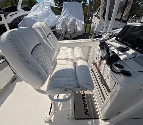 Slide: The Image of 2021 Sportsman Open 232 boat interior with white seating and control panel. - 24