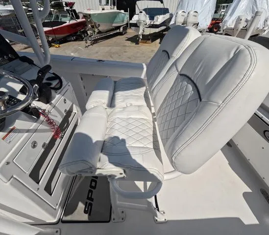 Slide: The Image of 2021 Sportsman Open 232 boat interior with white leather seating and steering console. - 25