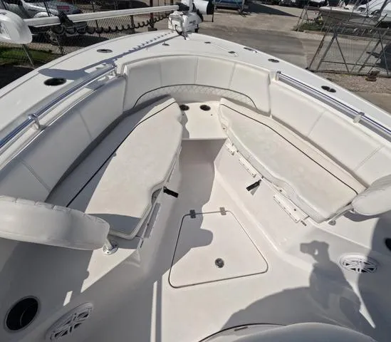 Slide: The Image of 2021 Sportsman Open 232 boat interior with cushioned seating and storage. - 26