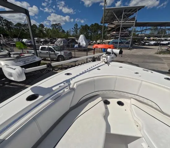 Slide: The Image of 2021 Sportsman Open 232 boat with trailer, parked in marina under clear sky. - 27