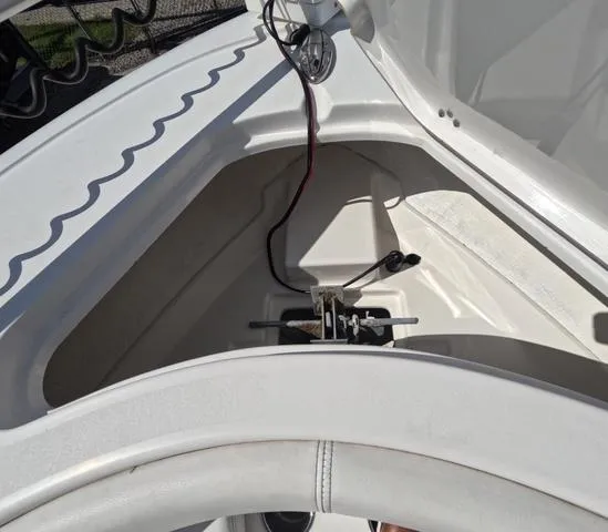 Slide: The Image of 2021 Sportsman Open 232 boat interior, showcasing storage compartment and wiring. - 29