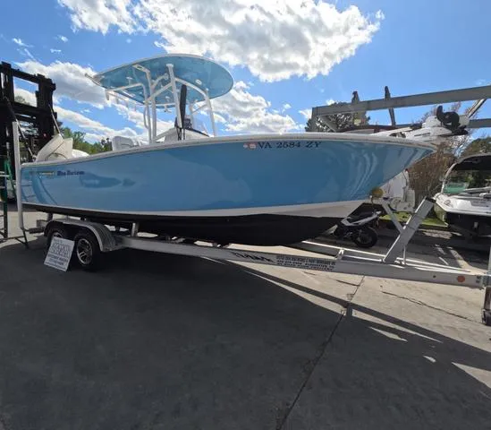 Slide: The Image of 2021 Sportsman Open 232 boat on trailer, low hours, blue hull, sunny day. - 3