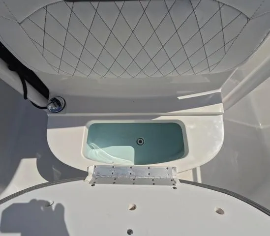 Slide: The Image of 2021 Sportsman Open 232 boat interior with storage compartment and cushioned seating. - 32