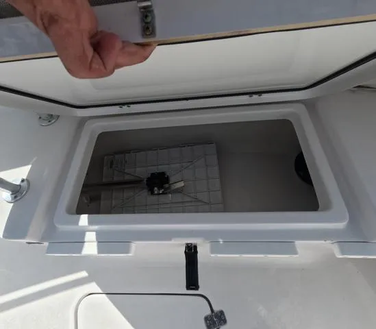 Slide: The Image of Open storage compartment on a 2021 Sportsman Open 232 boat, showing interior details. - 35