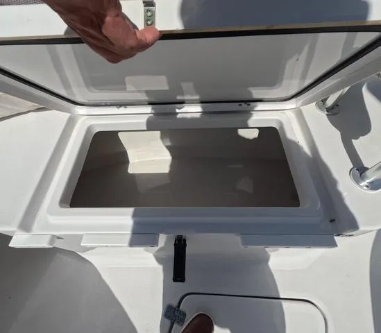 Slide: The Image of Open storage compartment on 2021 Sportsman Open 232 boat, showcasing interior space. - 36