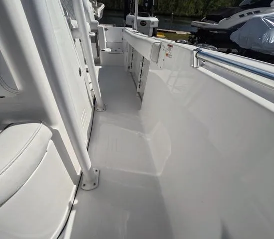 Slide: The Image of 2021 Sportsman Open 232 boat interior, showcasing sleek white deck and seating. - 38