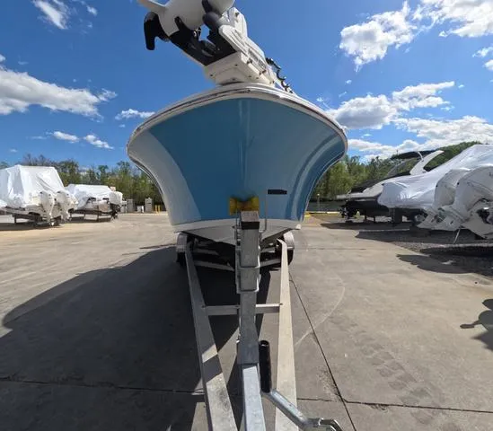 Slide: The Image of 2021 Sportsman Open 232 boat on trailer under clear blue sky. - 4