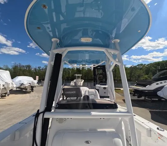Slide: The Image of 2021 Sportsman Open 232 boat with blue T-top, parked outdoors, trailer included. - 41