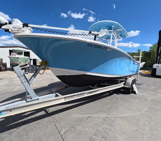 Slide: The Image of 2021 Sportsman Open 232 boat on trailer, blue hull, clear sky background. - 7
