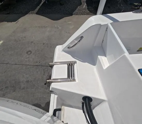 Slide: The Image of 2021 Sportsman Open 232 boat with foldable ladder and clean deck design. - 9