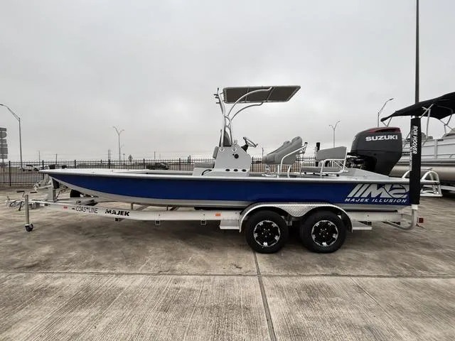 Slide: The Image of 2024 Majek M2 ILLUSION boat on trailer, featuring Suzuki engine, parked outdoors. - 1