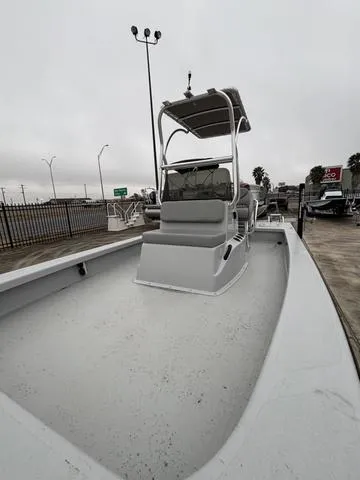 Slide: The Image of 2024 Majek M2 ILLUSION boat with T-top, parked outdoors on a cloudy day. - 4