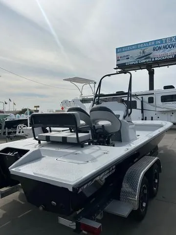 Slide: The Image of 2025 Majek 24 Reaper boat on trailer at dealership, showcasing sleek design and modern features. - 5