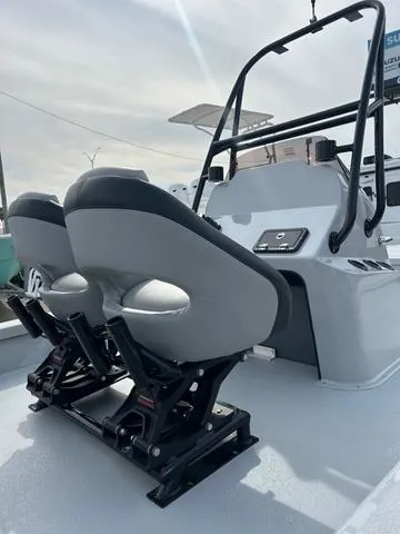 Slide: The Image of 2025 Majek 24 Reaper boat with dual cushioned seats and sleek console design. - 6