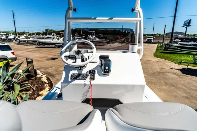 Slide: The Image of 2025 Majek M2 ILLUSION boat dashboard with steering wheel and controls, parked outdoors. - 10