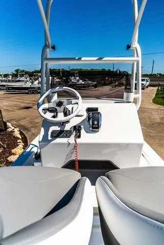 Slide: The Image of 2025 Majek M2 ILLUSION boat interior with steering wheel and controls, sunny day. - 11