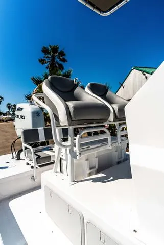 Slide: The Image of 2025 Majek M2 ILLUSION boat with dual seats and Suzuki engine, under clear blue sky. - 14
