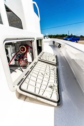 Slide: The Image of 2025 Majek M2 ILLUSION boat with open storage compartments, showcasing interior wiring. - 16