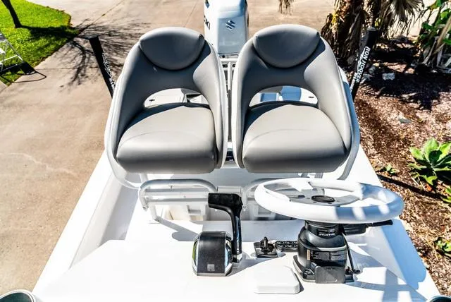 Slide: The Image of 2025 Majek M2 ILLUSION boat cockpit with dual seats and steering wheel. - 23