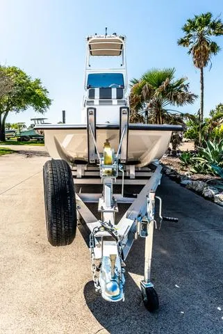 Slide: The Image of 2025 Majek M2 ILLUSION boat on trailer, parked outdoors with palm trees in the background. - 3