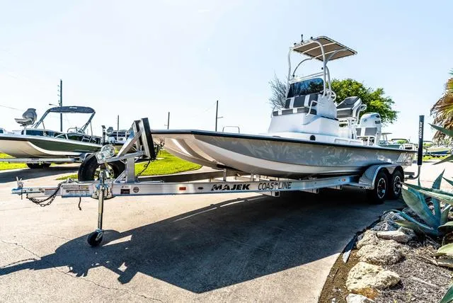Slide: The Image of 2025 Majek M2 ILLUSION boat on trailer, parked outdoors in sunny setting. - 4