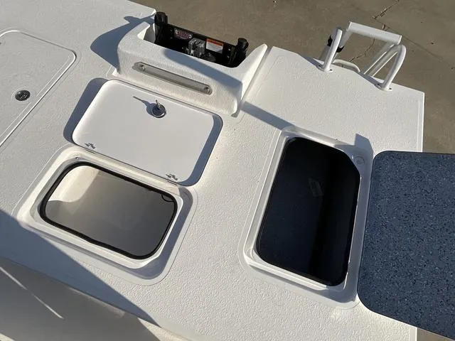 Slide: The Image of 2025 Majek 24 Reaper boat deck with storage compartments and utility features. - 16