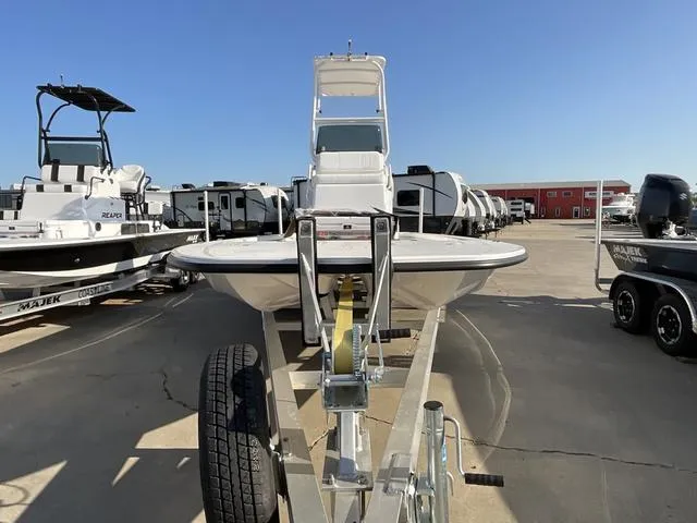 Slide: The Image of 2025 Majek 24 Reaper boat on trailer in outdoor showroom. - 2