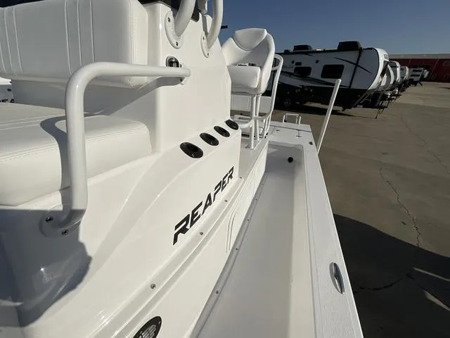 Slide: The Image of 2025 Majek 24 Reaper boat interior with white seating and sleek design. - 9