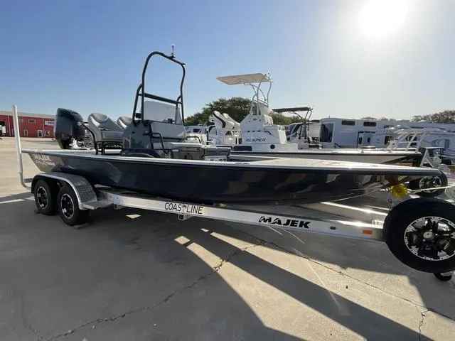 Slide: The Image of 2025 Majek 22 XTREME boat on trailer, parked outdoors under bright sunlight. - 1